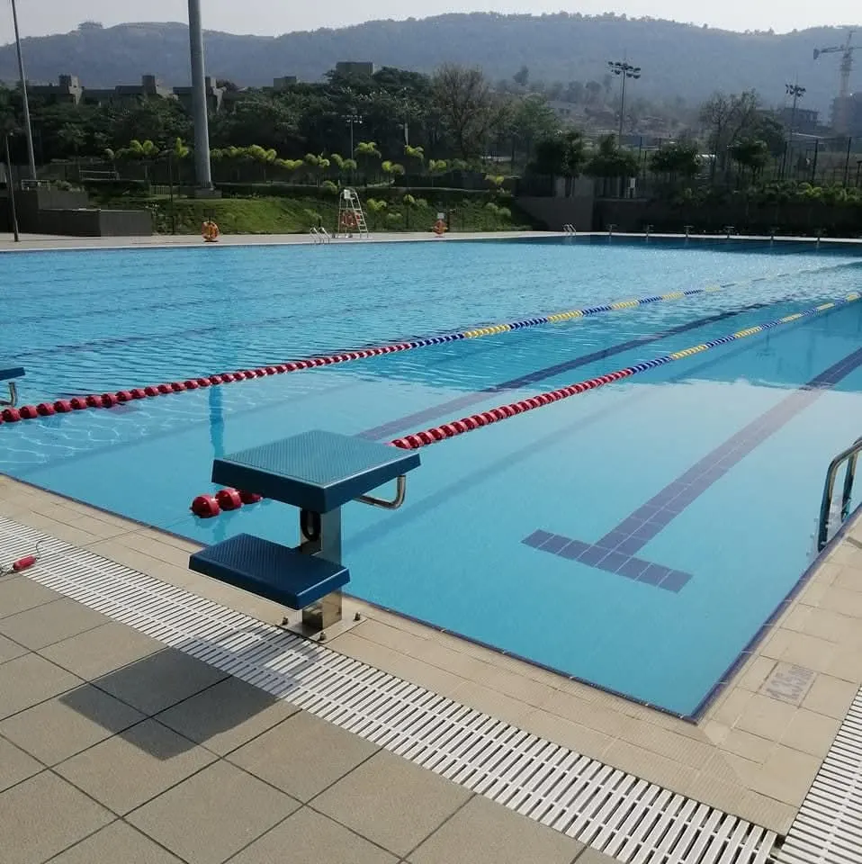 Commercial lap pool with lane ropes, starting block and overflow grating