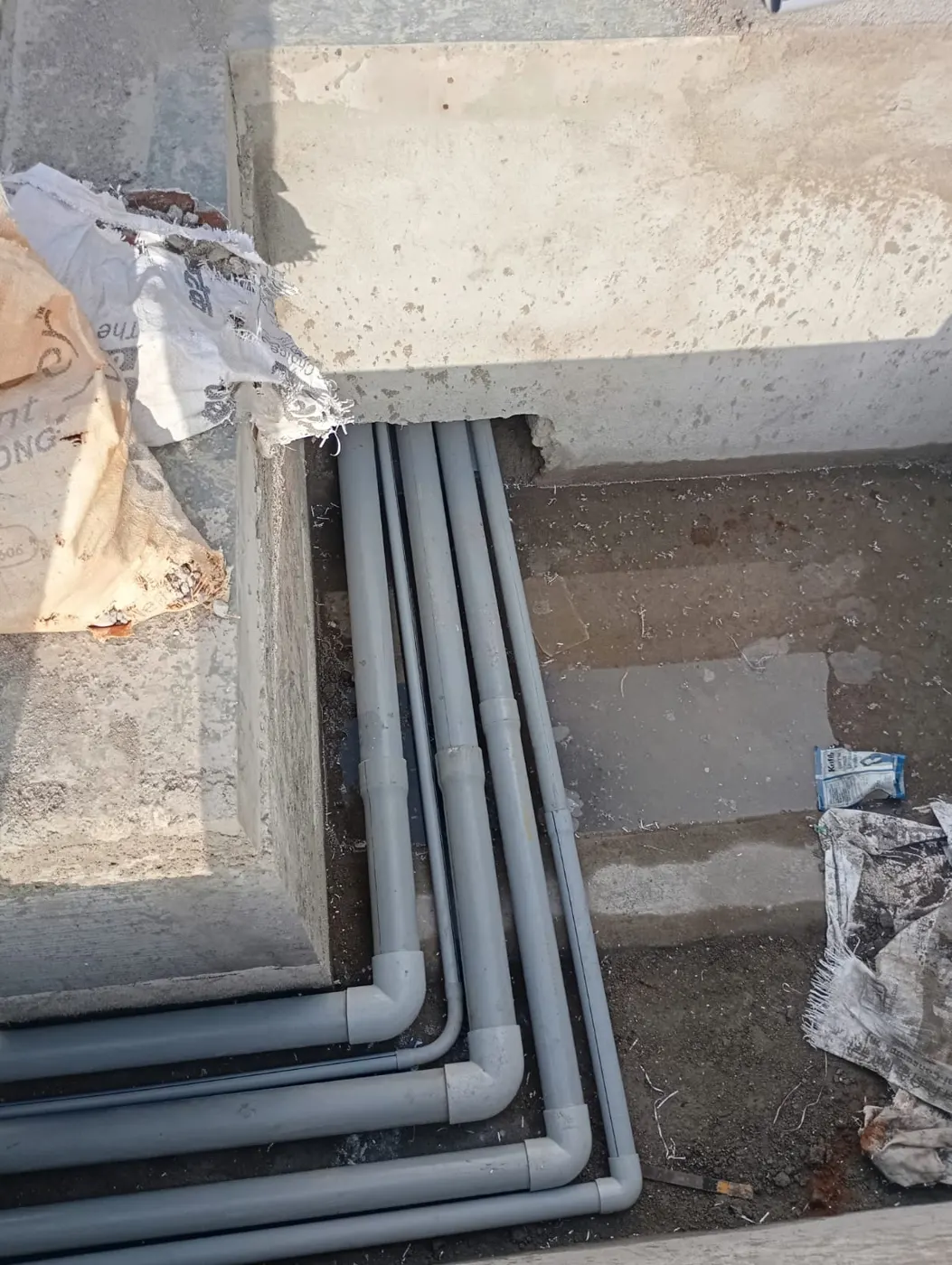 Swimming pool PVC pipework laid before deck finishing