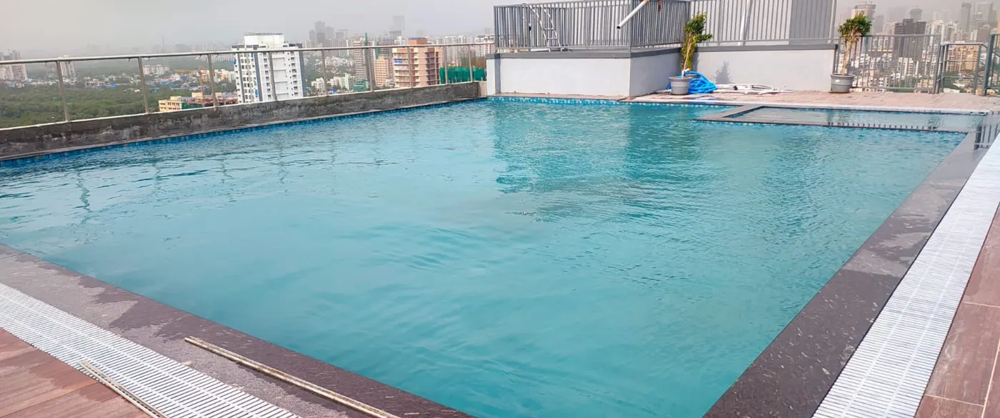Rooftop overflow swimming pool with perimeter grating and kids pool section